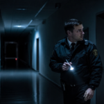 Security guard in a dim corridor